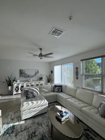 a living room with furniture and a large window