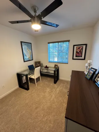 a view of a livingroom with workspace and a window