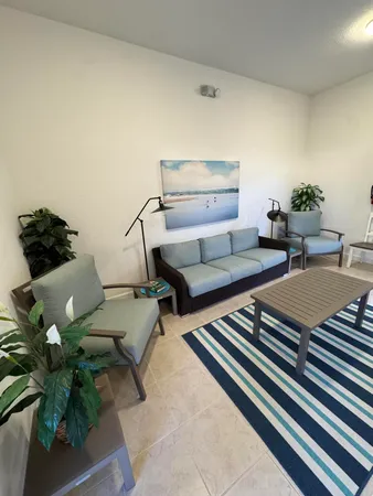 a living room with furniture and a potted plant