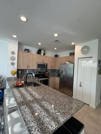 a kitchen with a refrigerator and a sink