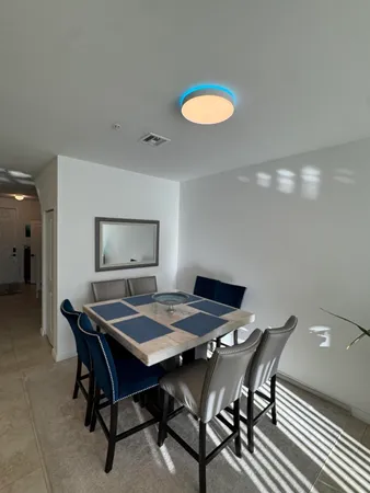a dining room with a table and chairs