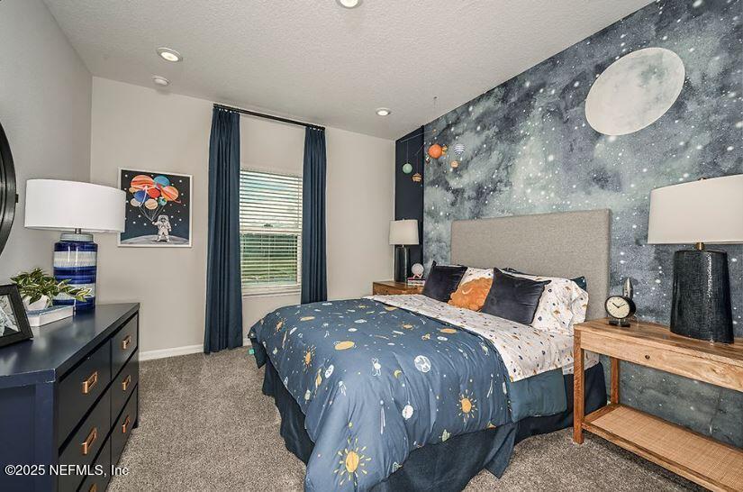 299 Cherry Elm Drive St. Augustine, FL 32092 - Photo 11 of 18 a bedroom with a bed and dresser with mirror