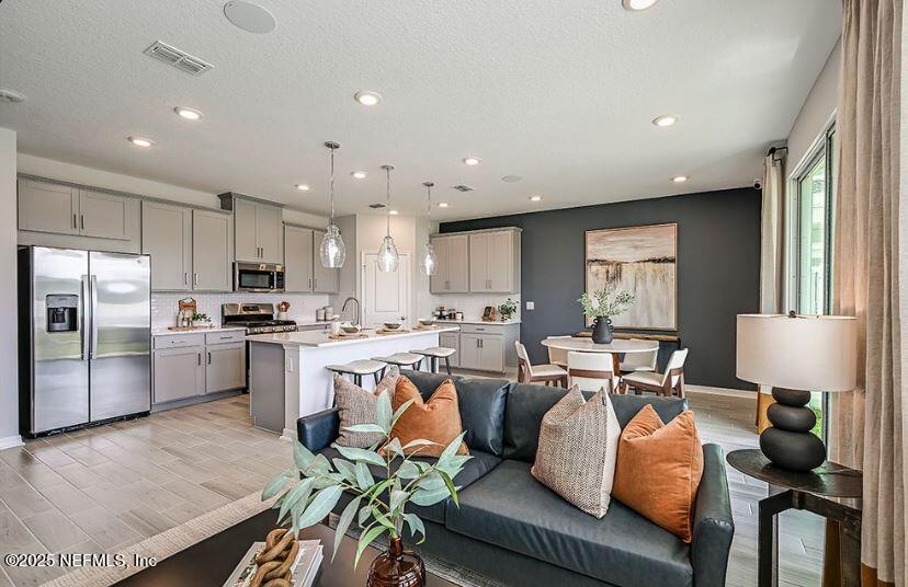 299 Cherry Elm Drive St. Augustine, FL 32092 - Photo 6 of 18 a living room with stainless steel appliances furniture and a view of kitchen
