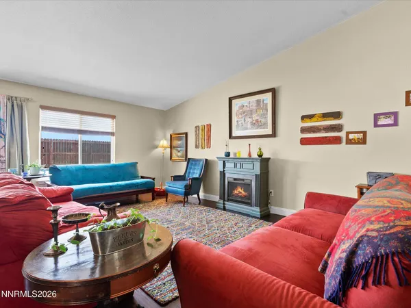 a living room with furniture a window and a fireplace