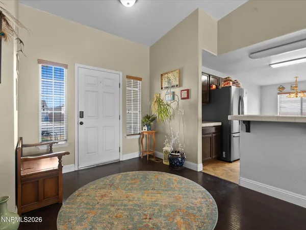 a spacious bedroom with a bed and wooden floor