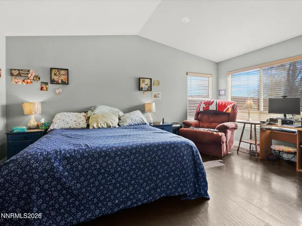 a bedroom with bed and wooden floor