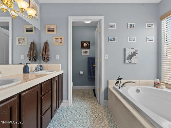 a bathroom with a tub sink and mirror