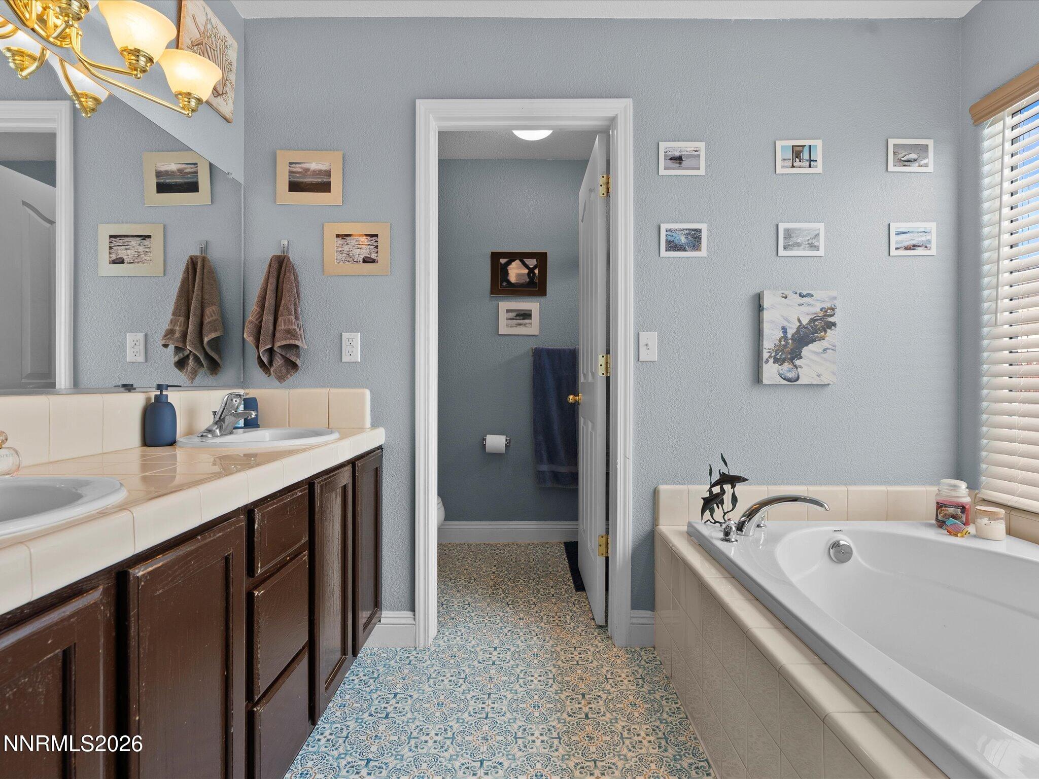 710 Keppel Street Fallon, NV 89406 - Photo 22 of 38 a bathroom with a tub sink and mirror