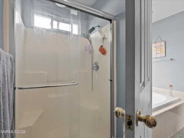 a bathroom with a shower and a sink