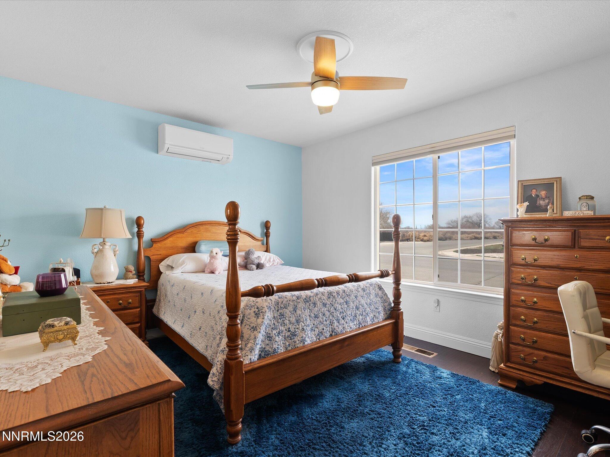 710 Keppel Street Fallon, NV 89406 - Photo 28 of 38 a bedroom with a bed and wooden floor