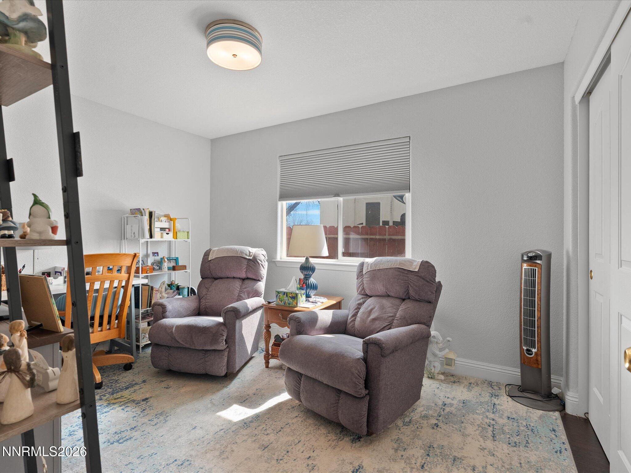 710 Keppel Street Fallon, NV 89406 - Photo 30 of 38 a living room with furniture a fireplace and a flat screen tv
