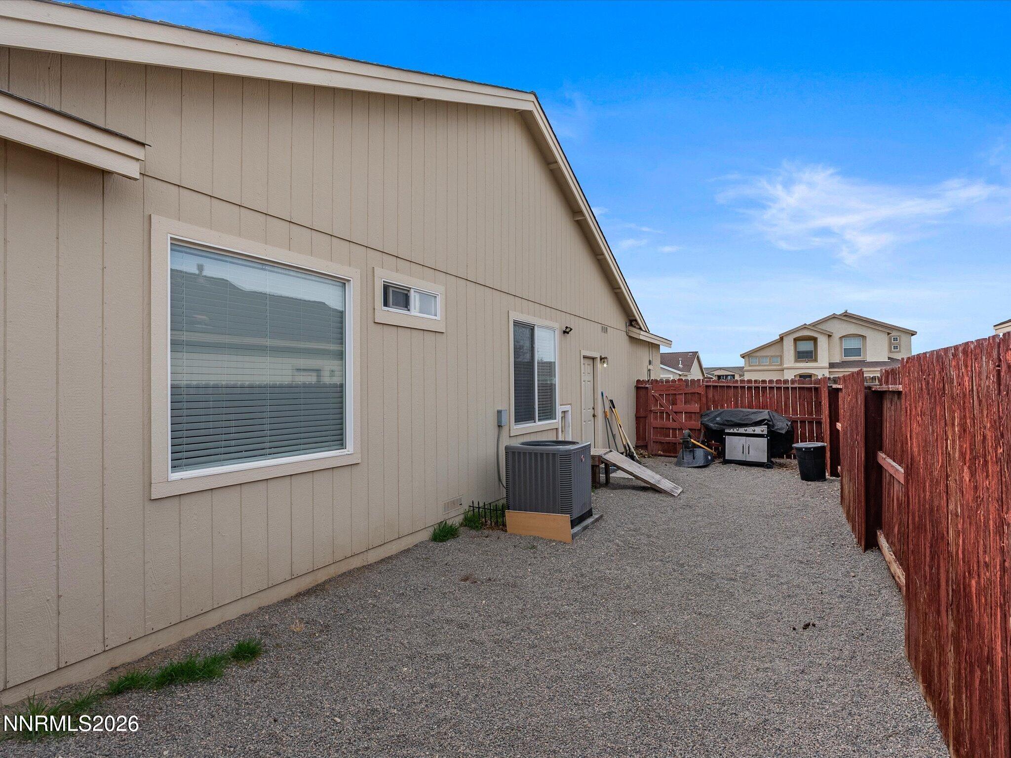 710 Keppel Street Fallon, NV 89406 - Photo 36 of 38 a view of a house with a barbeque and wooden fence