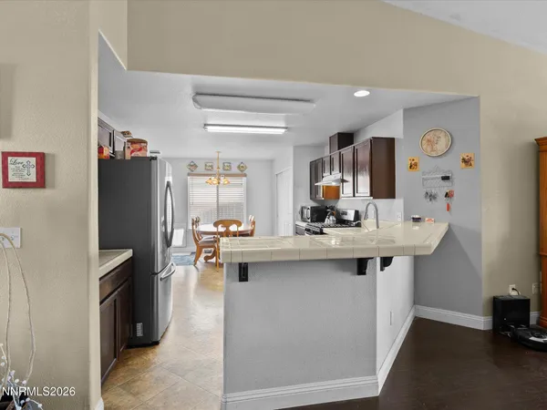 a kitchen with stainless steel appliances a sink stove and refrigerator