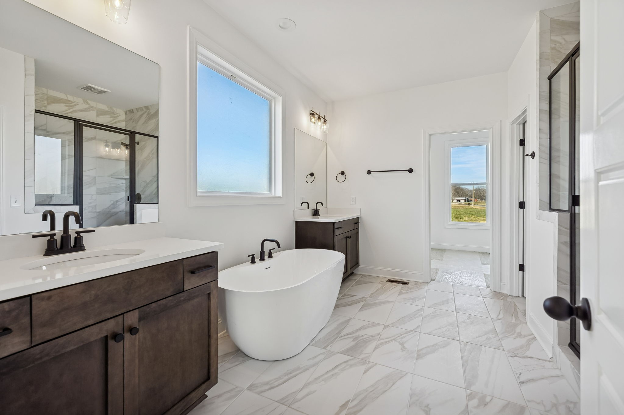 4741 Short Mountain Road Woodbury, TN 37190 - Photo 22 of 56 a bathroom with a double vanity sink a mirror and a bathtub