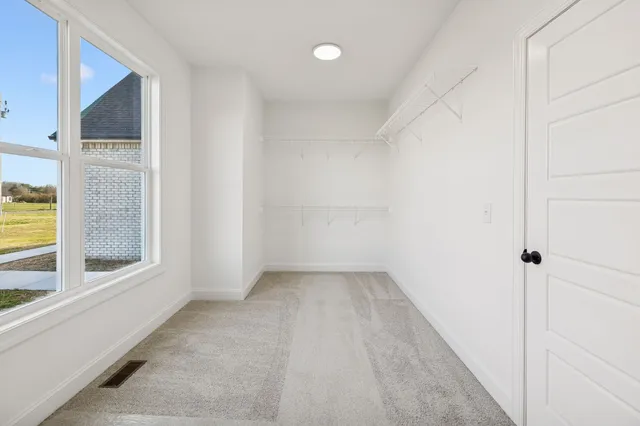 a spacious bathroom with a double vanity sink mirror and bathtub