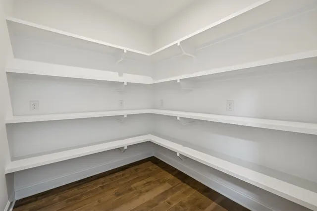 an empty room with a window and a ceiling fan