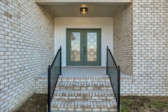 a view of a brick house with many windows