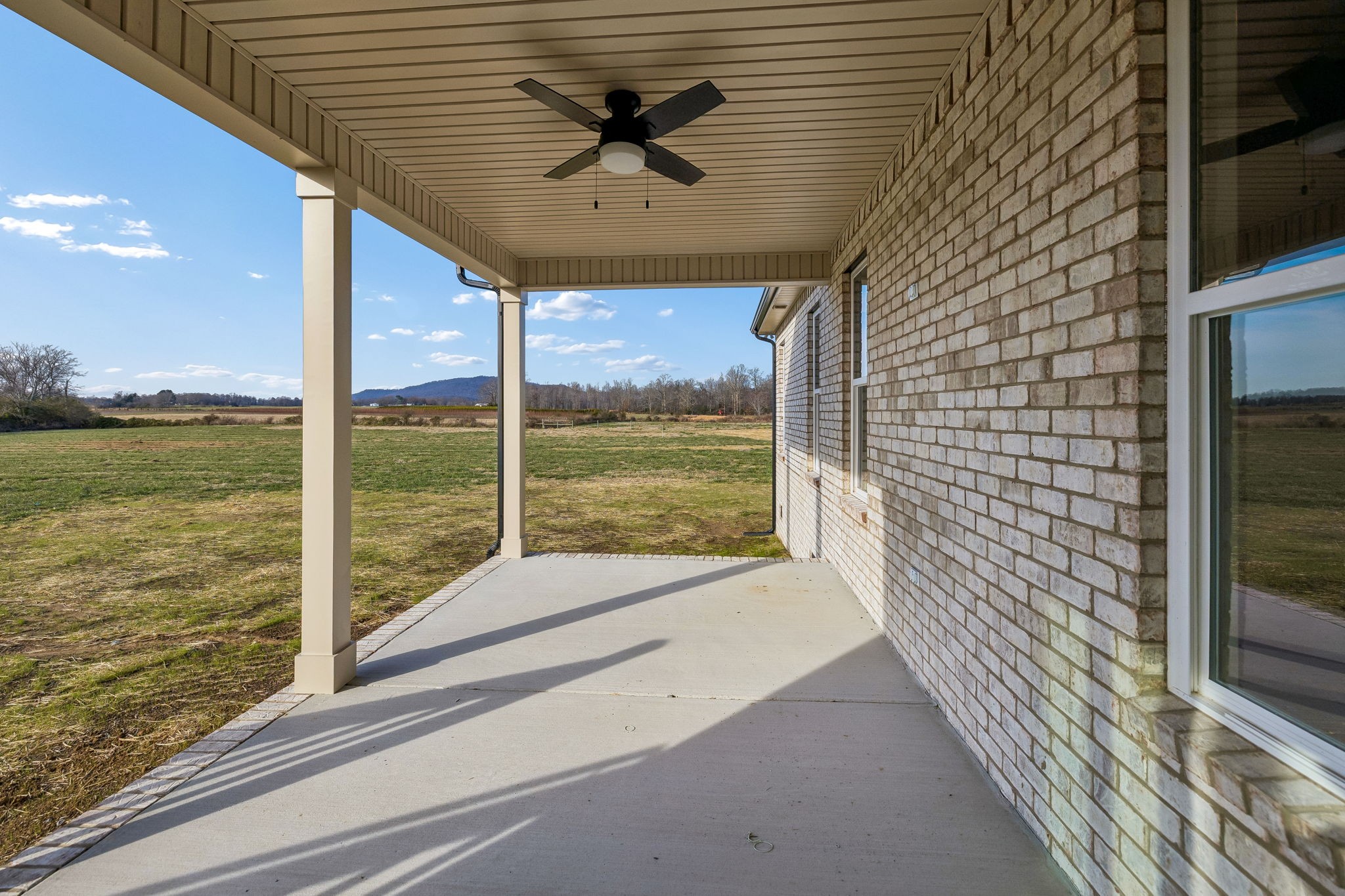 4741 Short Mountain Road Woodbury, TN 37190 - Photo 50 of 56 a view of a porch with a floor to ceiling window next to a yard