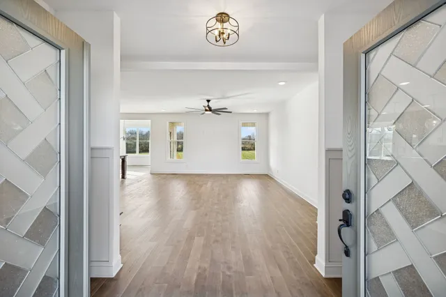 a view of an entryway with wooden floor
