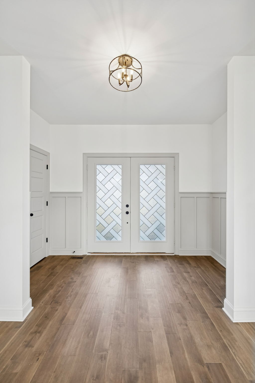 4741 Short Mountain Road Woodbury, TN 37190 - Photo 6 of 56 an empty room with wooden floor and windows