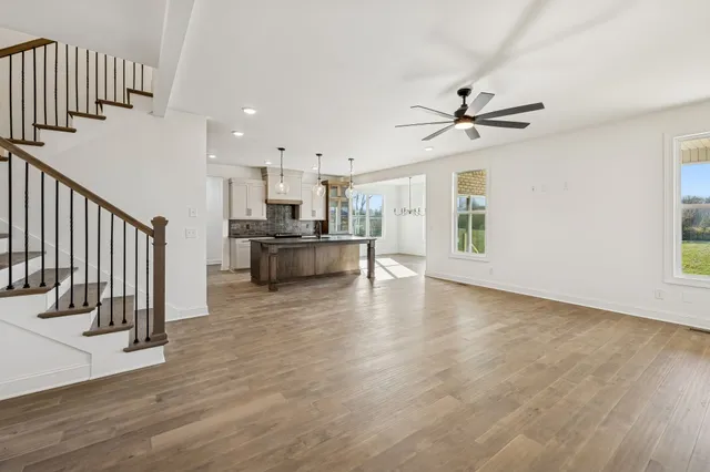 a view of a kitchen with furniture and a ceiling fan