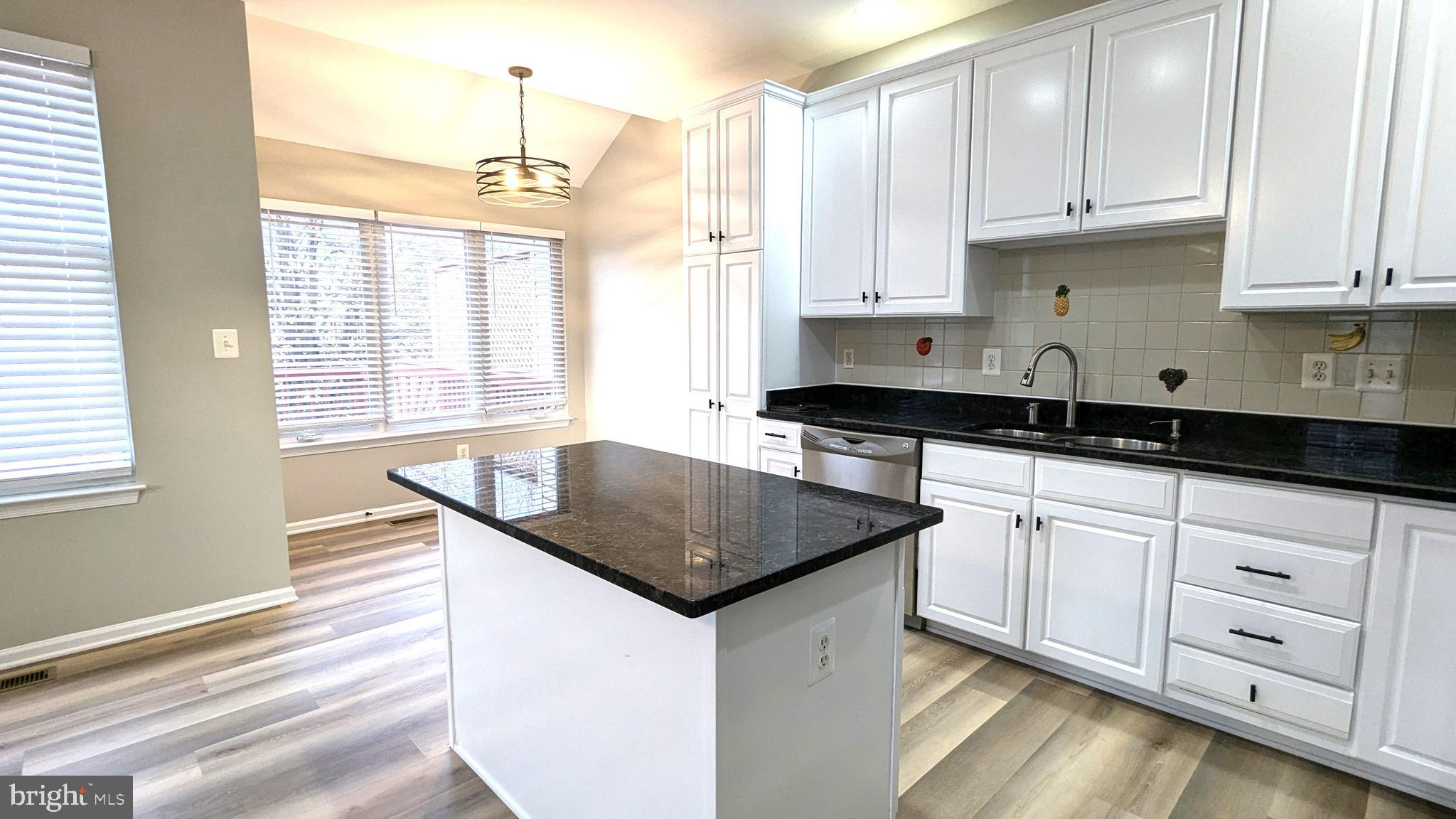 21506 Trowbridge Square Ashburn, VA 20147 - Photo 11 of 66 a kitchen with granite countertop white cabinets and a granite counter tops