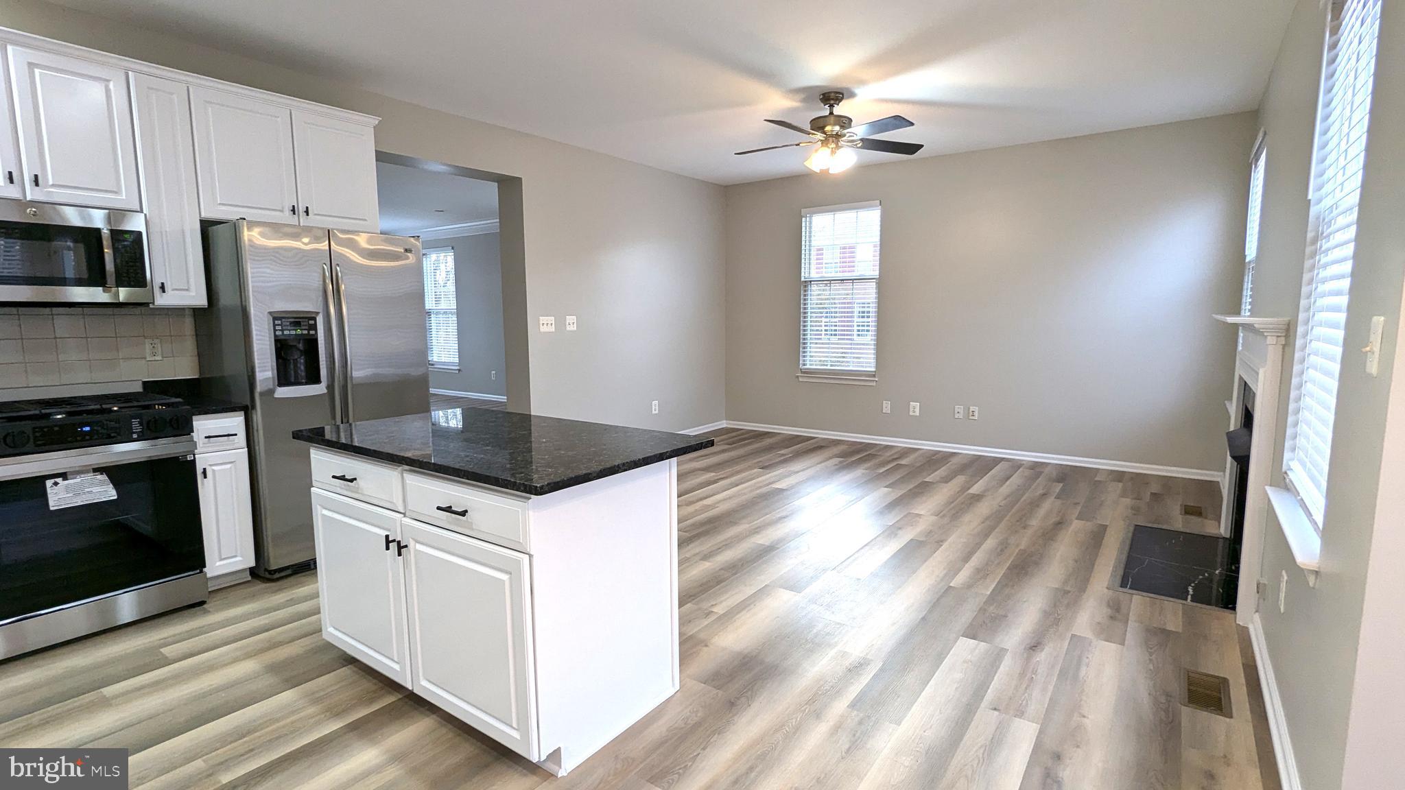 21506 Trowbridge Square Ashburn, VA 20147 - Photo 12 of 66 a kitchen with granite countertop a stove a sink and a refrigerator