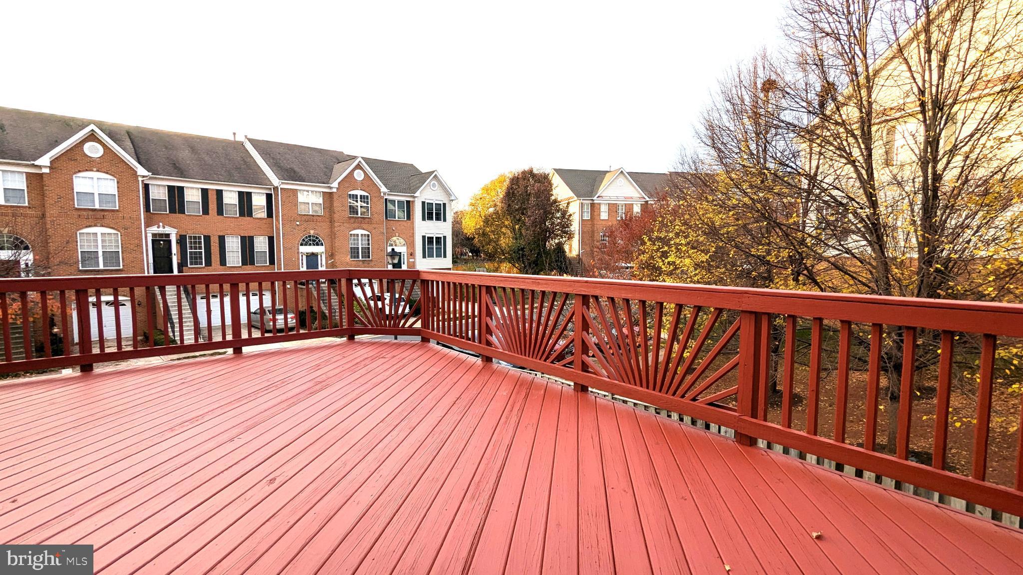 21506 Trowbridge Square Ashburn, VA 20147 - Photo 14 of 66 a view of a balcony with wooden floor and fence