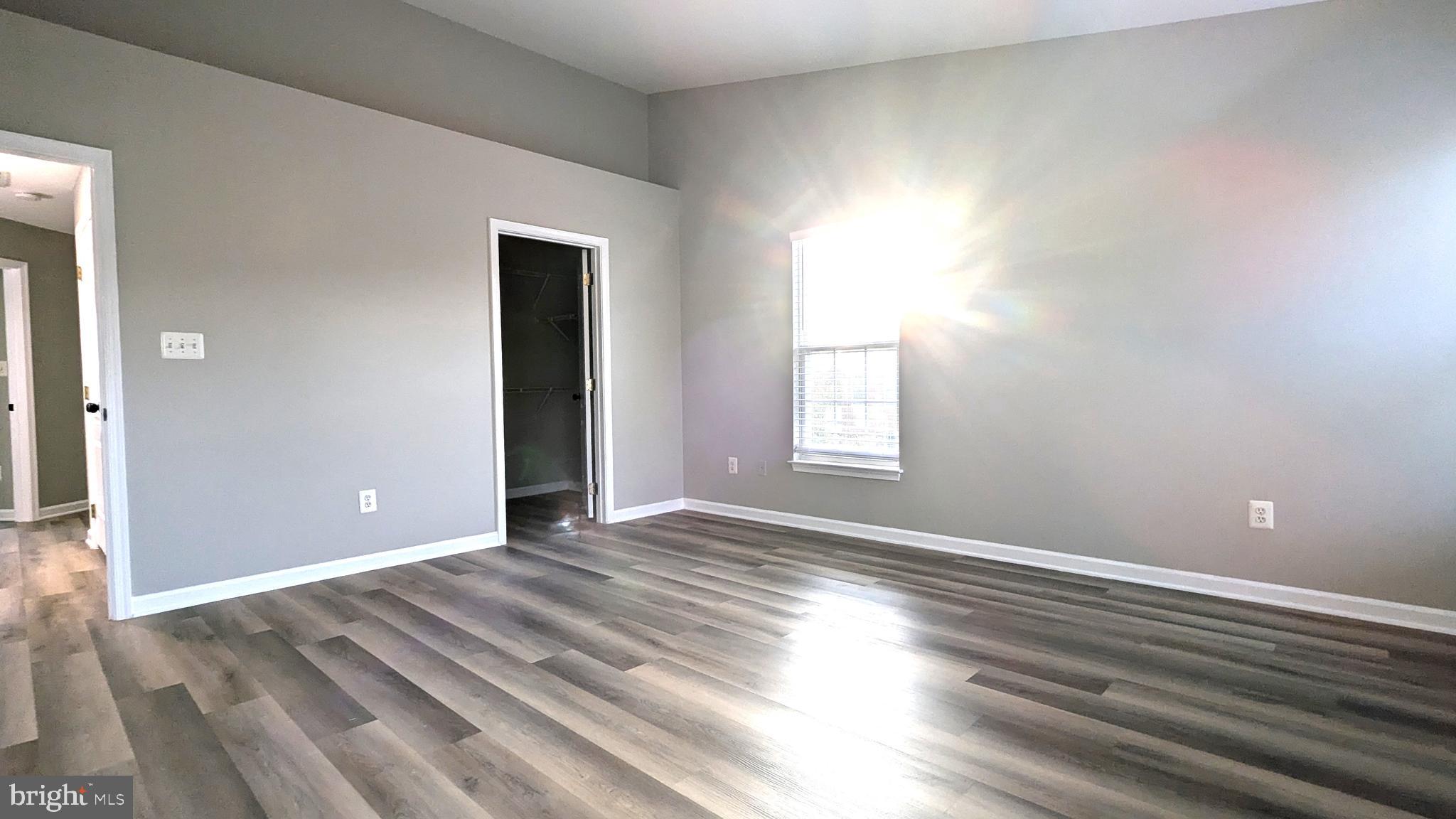 21506 Trowbridge Square Ashburn, VA 20147 - Photo 22 of 66 a view of an empty room with wooden floor and a window