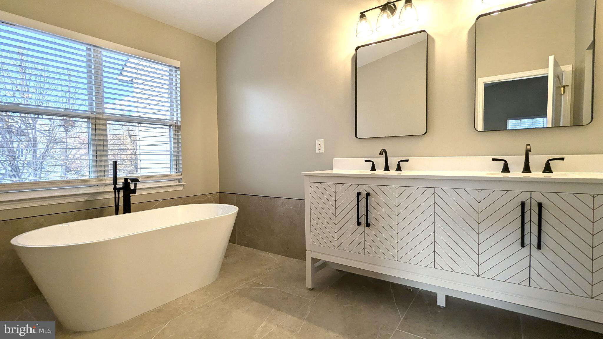 21506 Trowbridge Square Ashburn, VA 20147 - Photo 24 of 66 a spacious bathroom with a bathtub and a sink