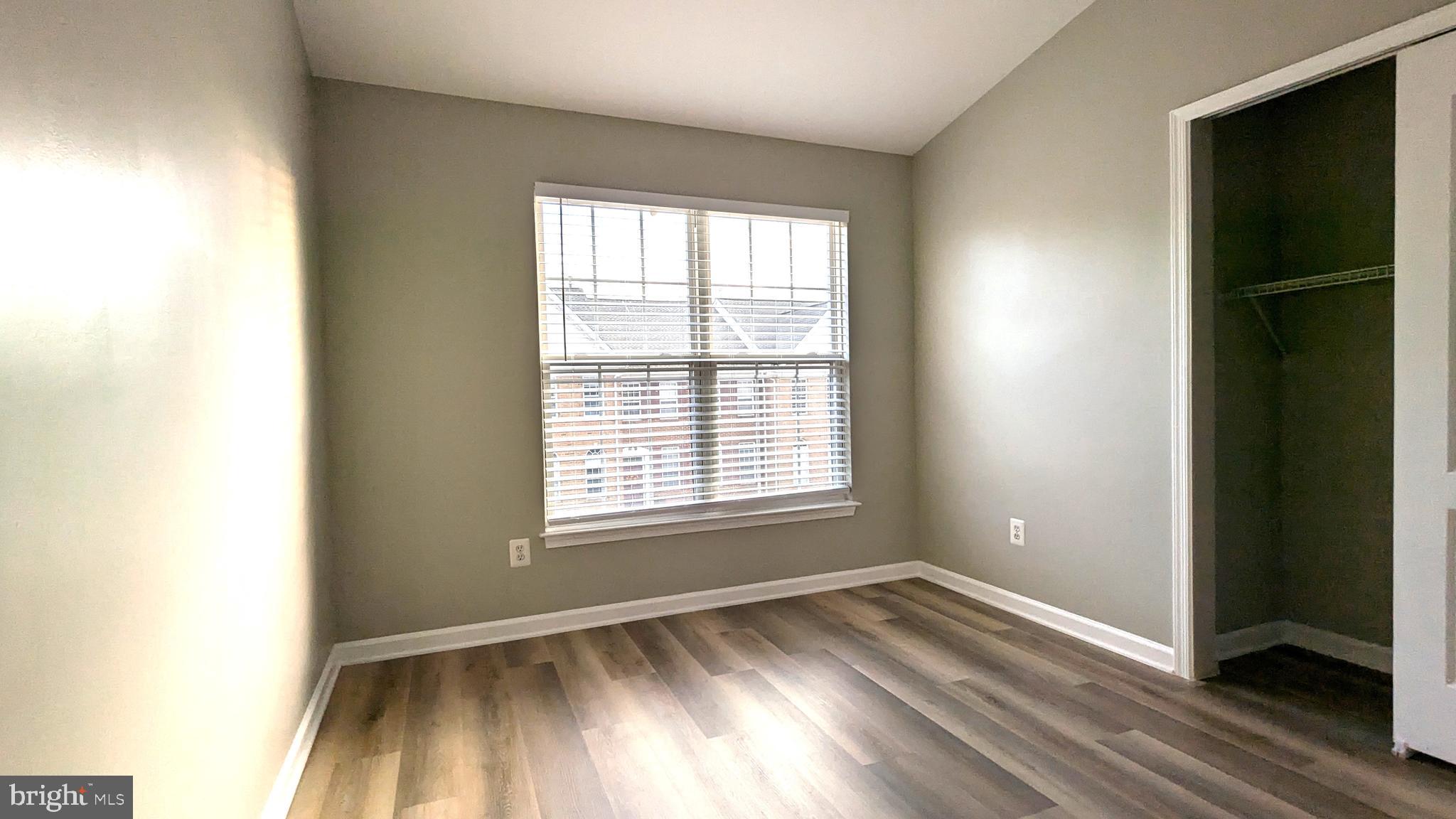 21506 Trowbridge Square Ashburn, VA 20147 - Photo 33 of 66 a view of an empty room with wooden floor and a window