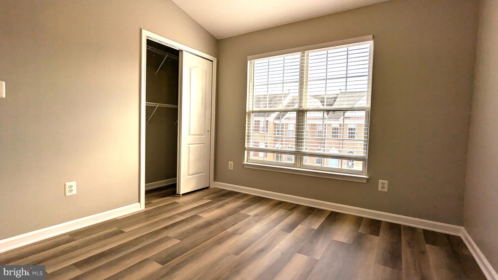 21506 Trowbridge Square Ashburn, VA 20147 - Photo 36 of 66 a view of an empty room with wooden floor and a window