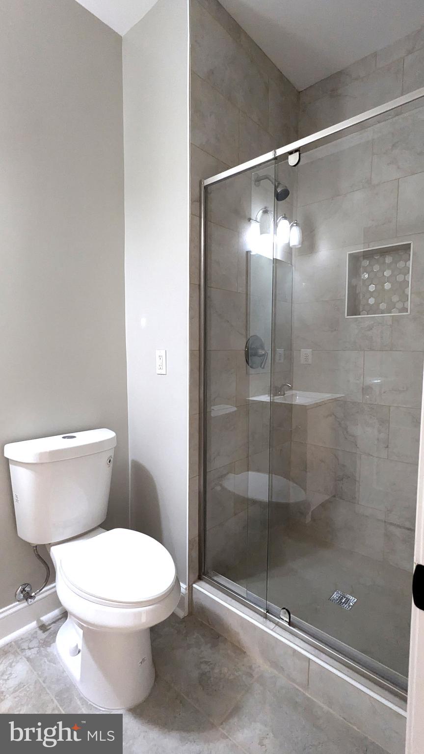 21506 Trowbridge Square Ashburn, VA 20147 - Photo 48 of 66 a white toilet sitting next to a shower