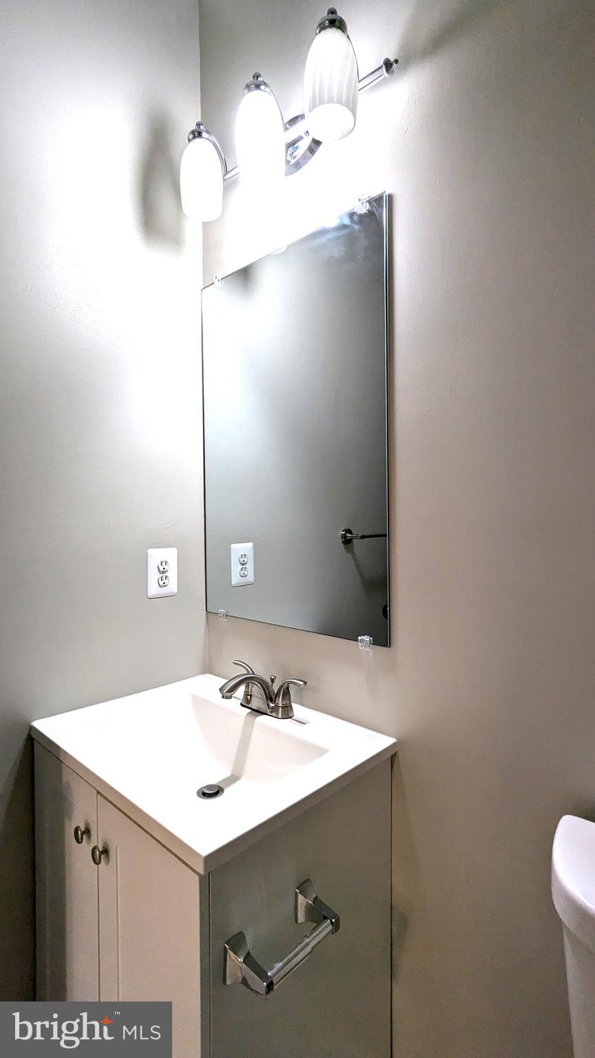 21506 Trowbridge Square Ashburn, VA 20147 - Photo 52 of 66 a bathroom with a sink and a mirror