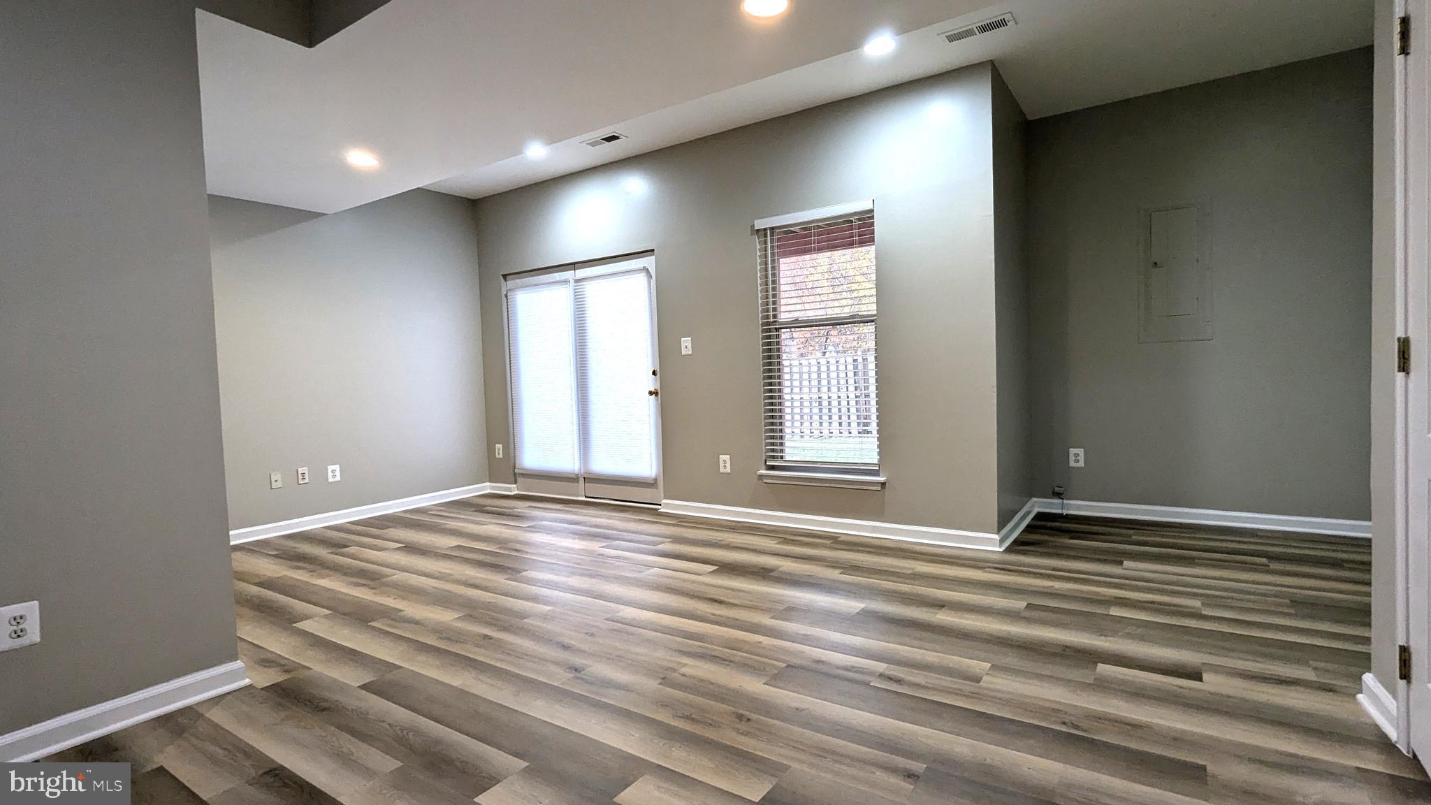 21506 Trowbridge Square Ashburn, VA 20147 - Photo 53 of 66 a view of an empty room with wooden floor and a window