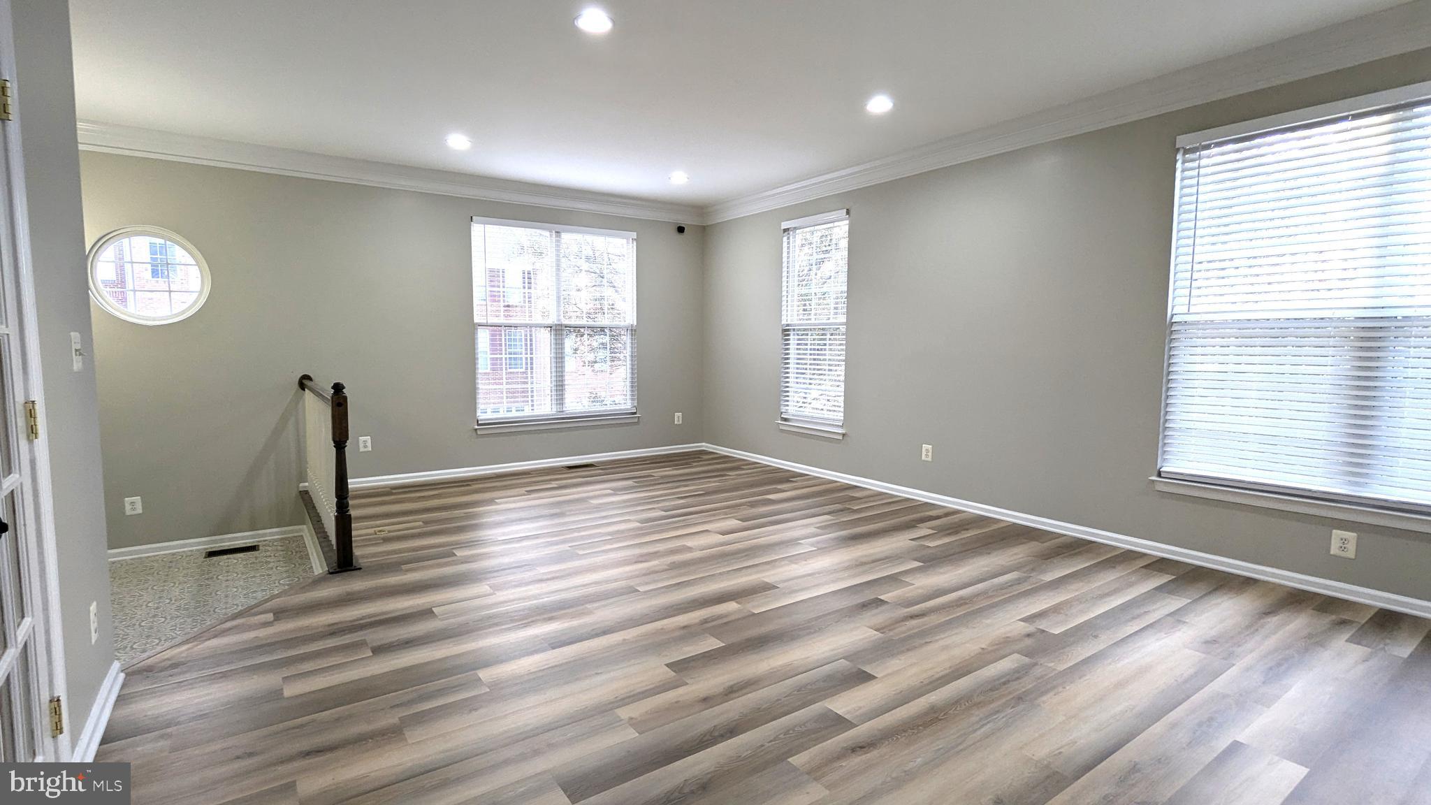 21506 Trowbridge Square Ashburn, VA 20147 - Photo 6 of 66 a view of empty room with wooden floor and fan