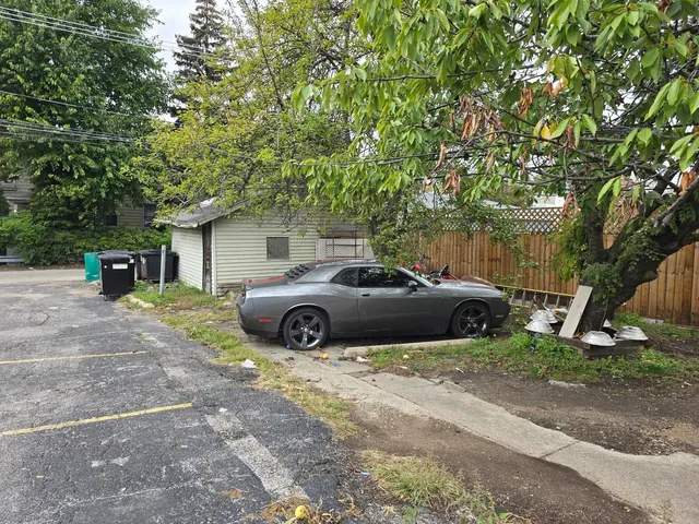 a view of a car parked in front of a house