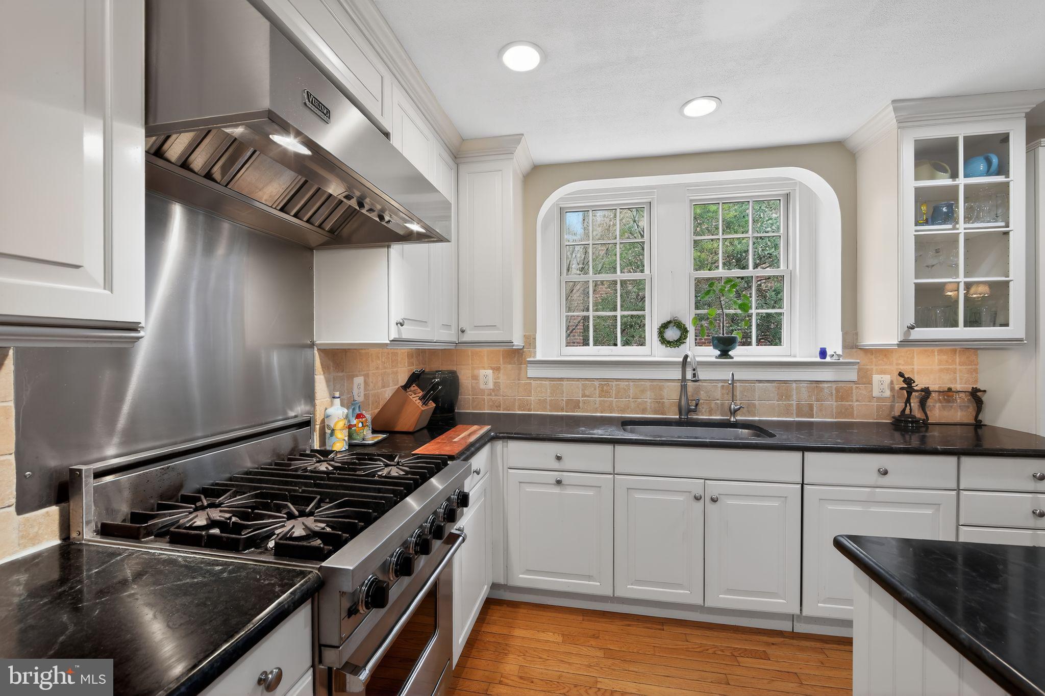 306 Windsor Avenue Wayne, PA 19087 - Photo 14 of 36 a kitchen with stainless steel appliances granite countertop a sink stove and cabinets