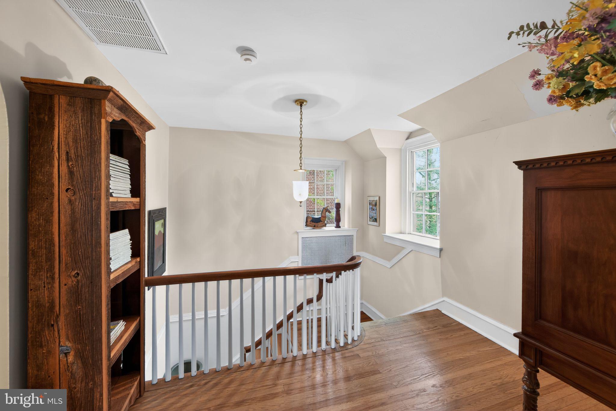 306 Windsor Avenue Wayne, PA 19087 - Photo 21 of 36 a view of a hallway with wooden floor and stairs