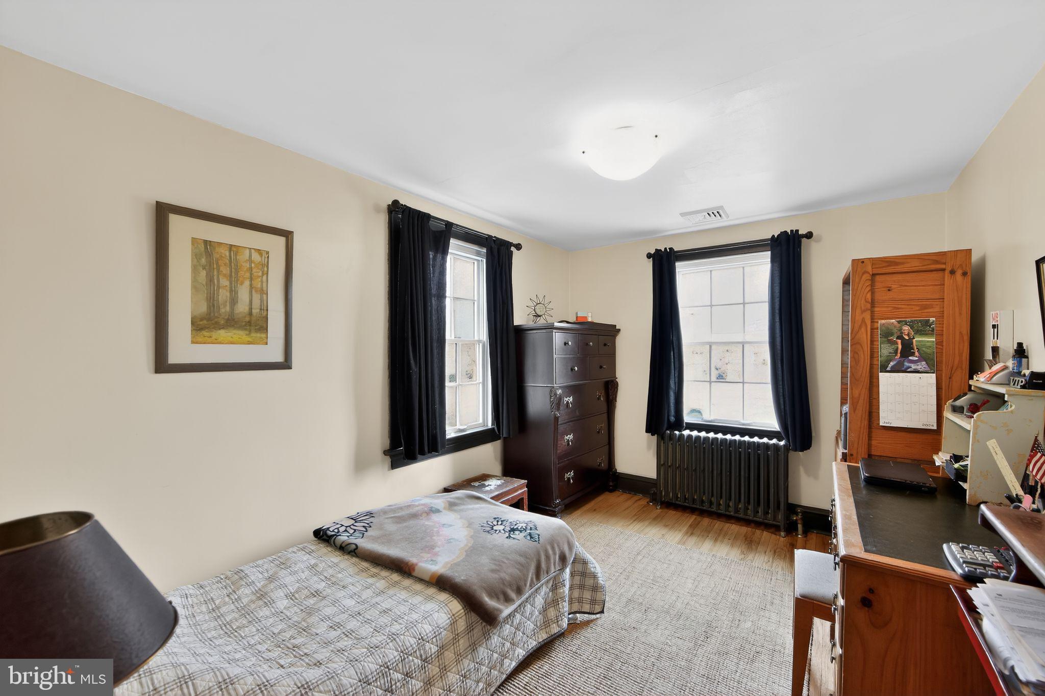 306 Windsor Avenue Wayne, PA 19087 - Photo 29 of 36 a bedroom with a bed and wooden floor