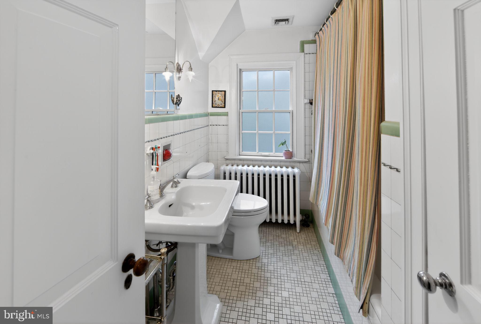 306 Windsor Avenue Wayne, PA 19087 - Photo 30 of 36 a bathroom with a sink a mirror and a window