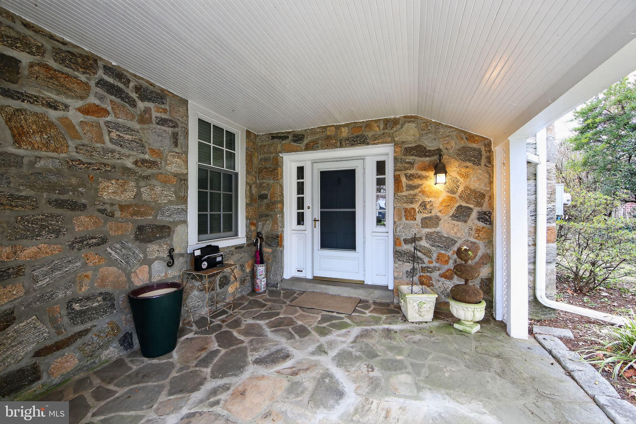 306 Windsor Avenue Wayne, PA 19087 - Photo 3 of 36 a view of a patio with table and chairs and potted plants