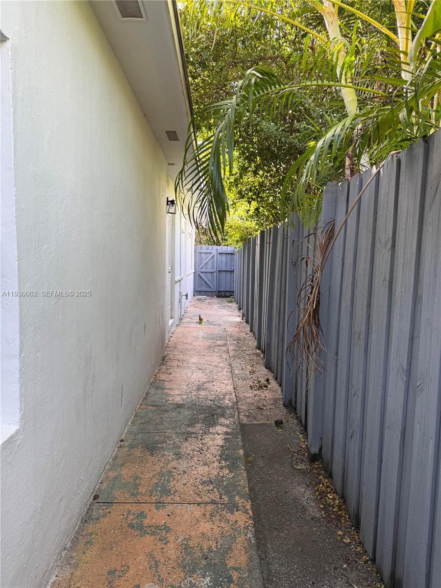 894 80th Street, Unit 1 Miami Beach, FL 33141 - Photo 13 of 13 a view of a pathway of a wooden fence