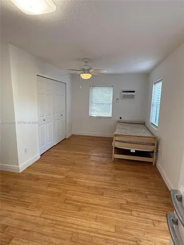 a view of room with stairs and wooden floor