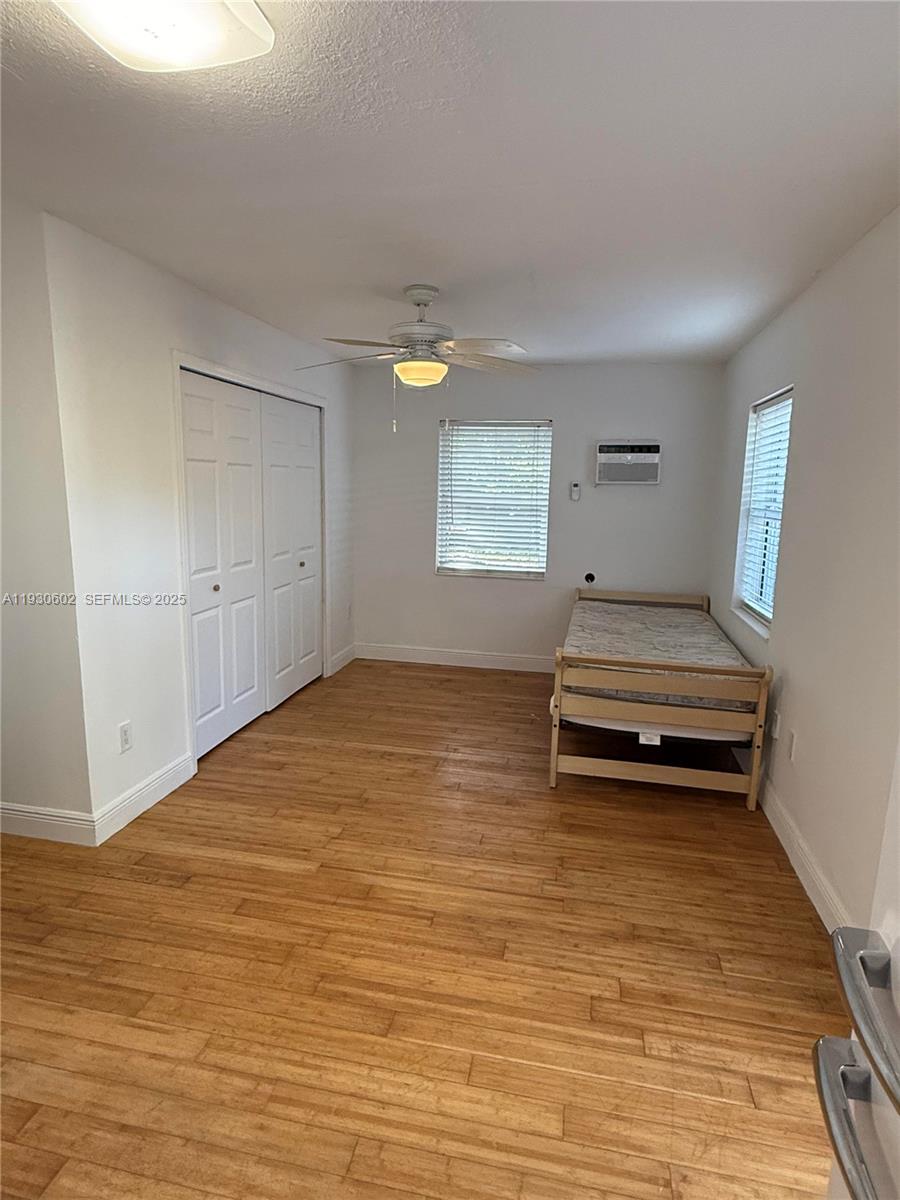 894 80th Street, Unit 1 Miami Beach, FL 33141 - Photo 4 of 13 a view of room with stairs and wooden floor