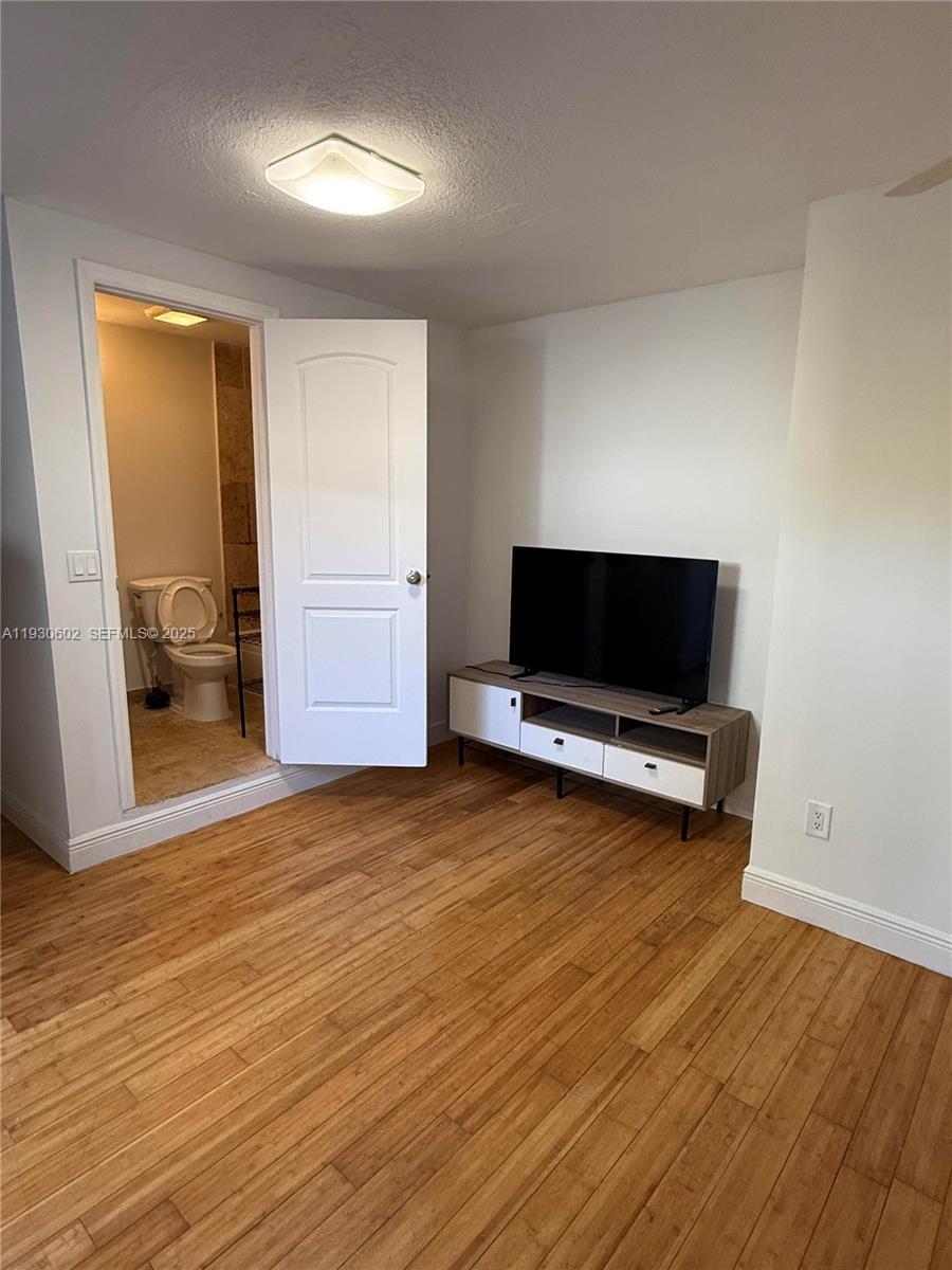 894 80th Street, Unit 1 Miami Beach, FL 33141 - Photo 5 of 13 a view of a livingroom with furniture and a flat screen tv