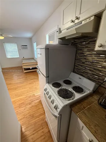 a kitchen with a stove and a microwave
