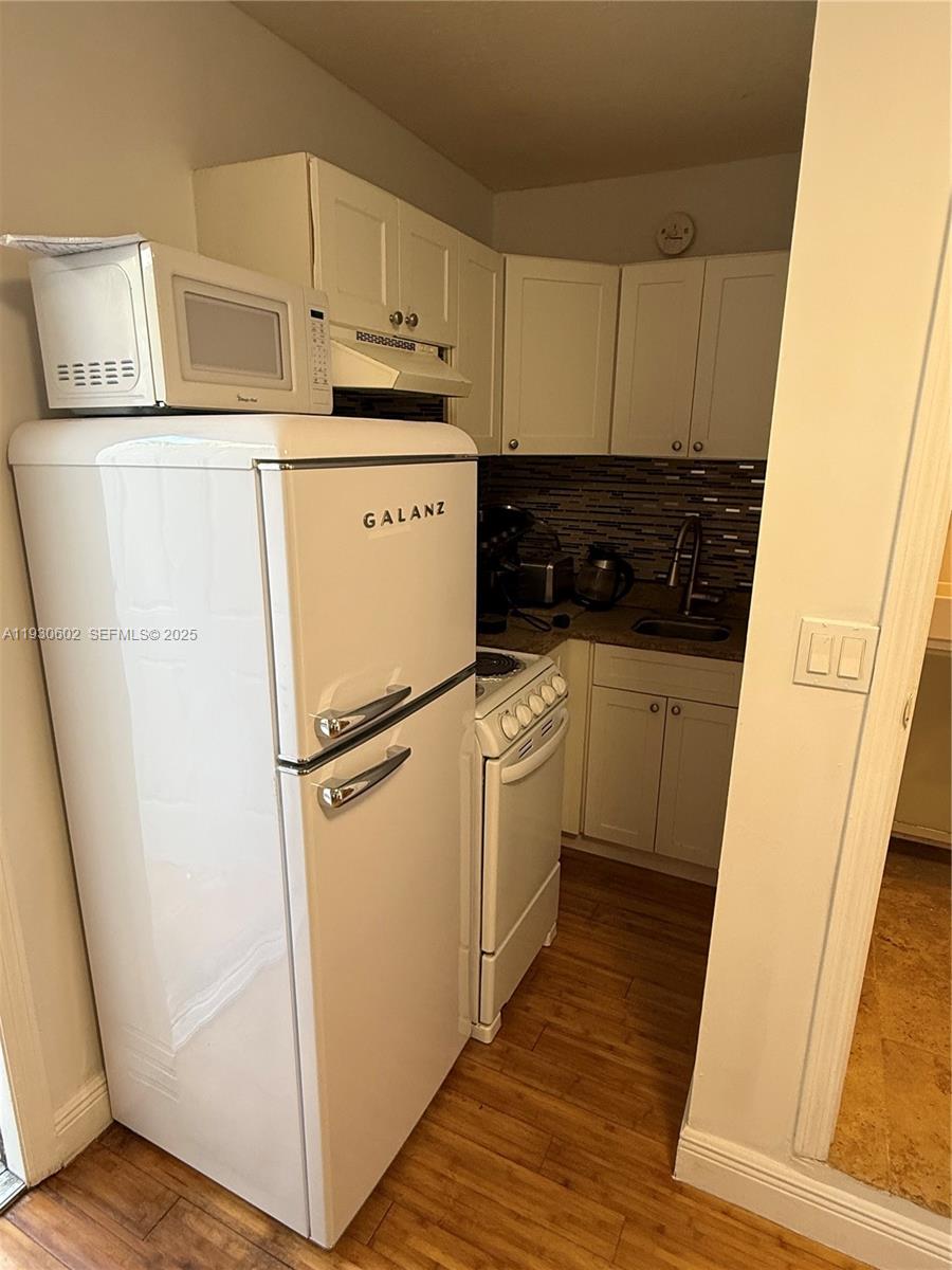 894 80th Street, Unit 1 Miami Beach, FL 33141 - Photo 9 of 13 a utility room with wooden floor washer and dryer