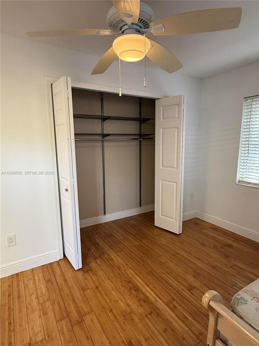 894 80th Street, Unit 1 Miami Beach, FL 33141 - Photo 10 of 13 an empty room with wooden floor and windows