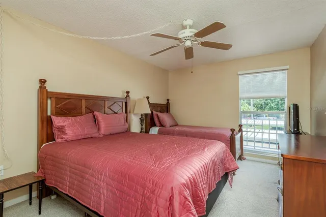 a bedroom with a large bed and a chandelier